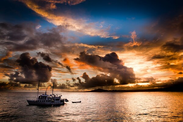 Yacht at sea at sunset near the coast