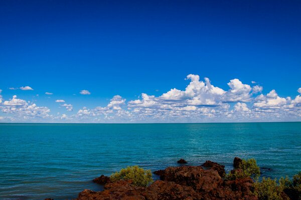 Cloudy sky over blue waves