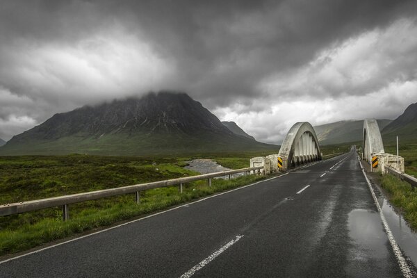 Automobile bridge on the background of autumn mountains