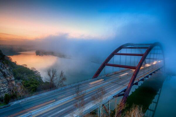 Foggy landscape. Bridge over the river