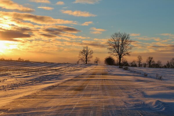 Snowdrift runs along the winter road