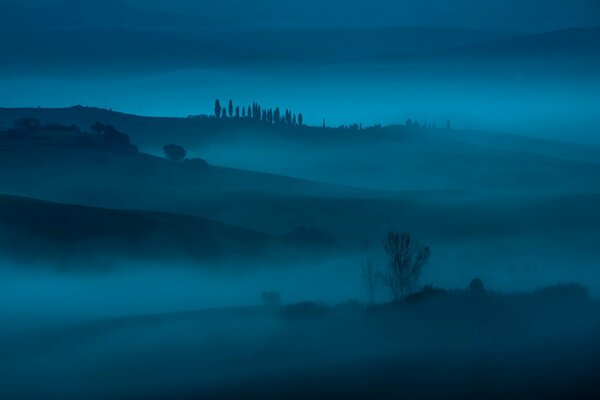 Morning fog over mountains and fields