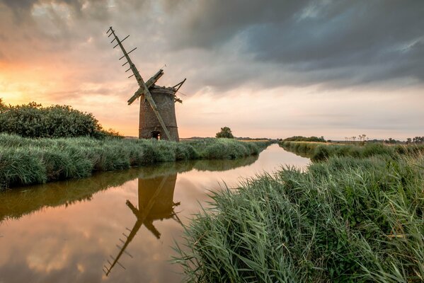 An abandoned mill. The river. Sunset