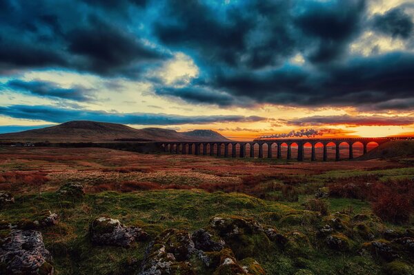 Cielo scuro sopra il ponte ferroviario al tramonto