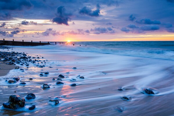 Sea surf at sunset