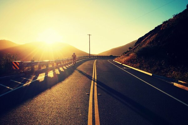 A cyclist rides on a flat road