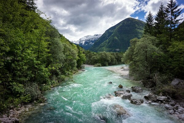 Türkisfarbener Bergfluss mit Stein