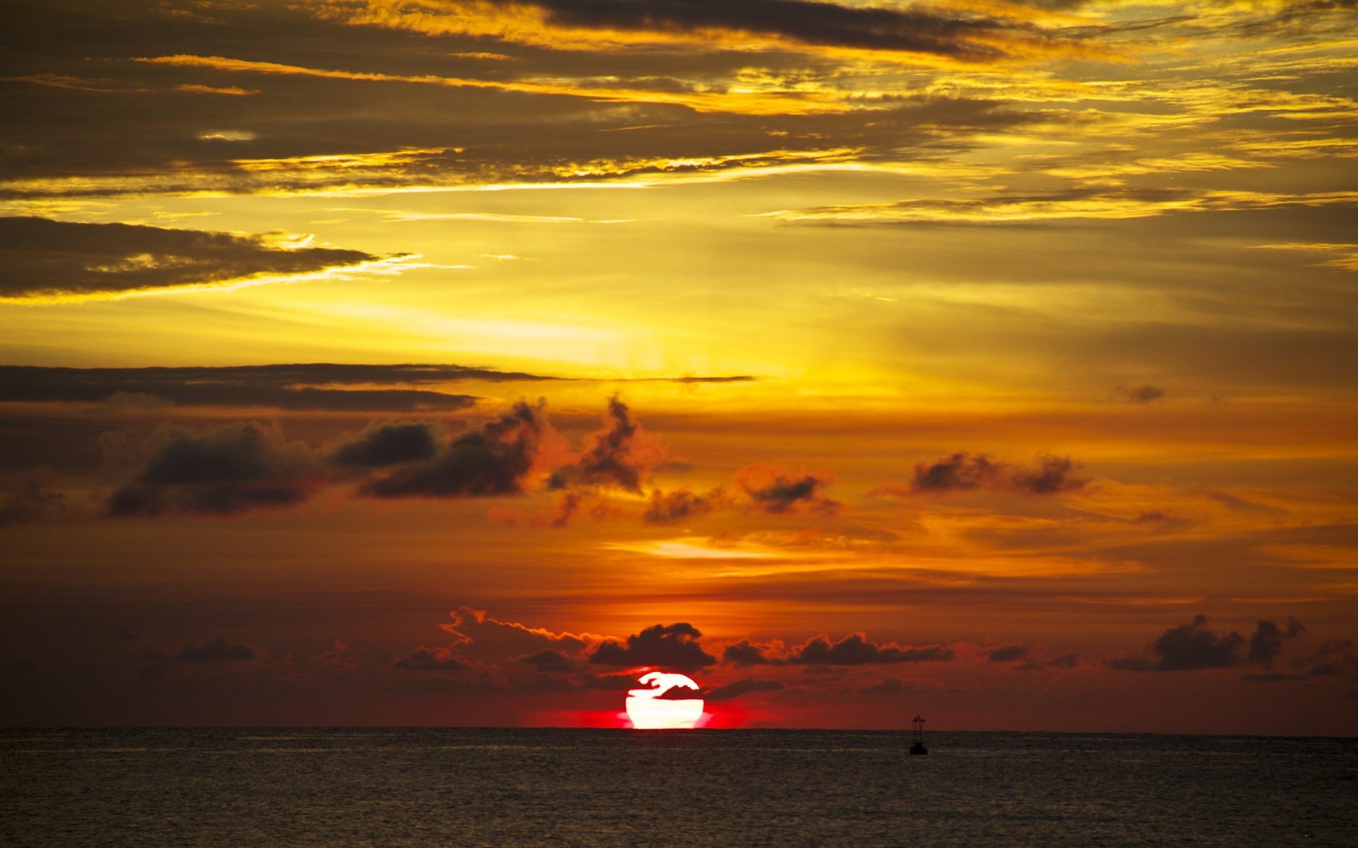 ea ocean water distance horizon sky clouds clouds silhouettes sun dawn sunset buoy