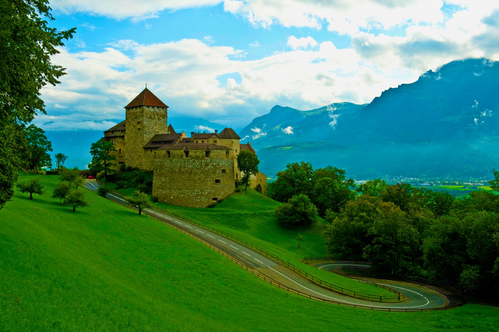 castle fortress old mountain tree sky clouds road grass summer