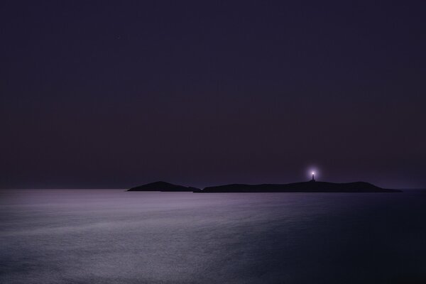 Purple island and a lighthouse in the distance