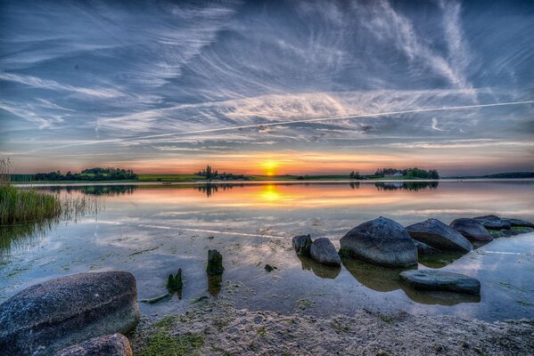 Sunset is reflected in the water of the lake