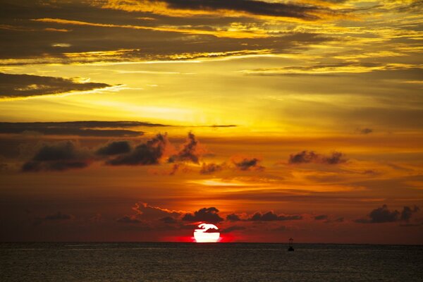 The sea with a beautiful sunset and a buoy