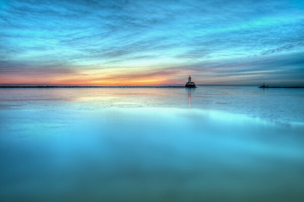 Mirrored landscape in azure shades. The sea at sunset