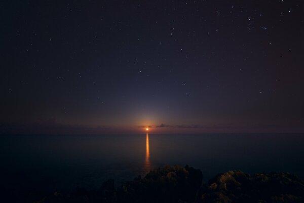 Night starry sky over the sea