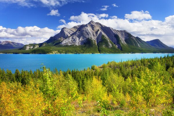 In autumn, Canada has a beautiful sky, mountains, lake, forest, trees