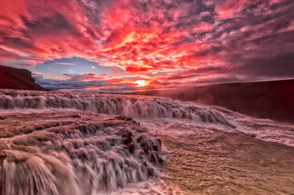 Scarlet sunset over the waterfall