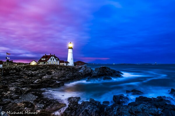 Burning lighthouse on the ocean