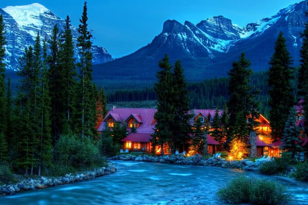 Winter river at the hotel in the mountains near the forest