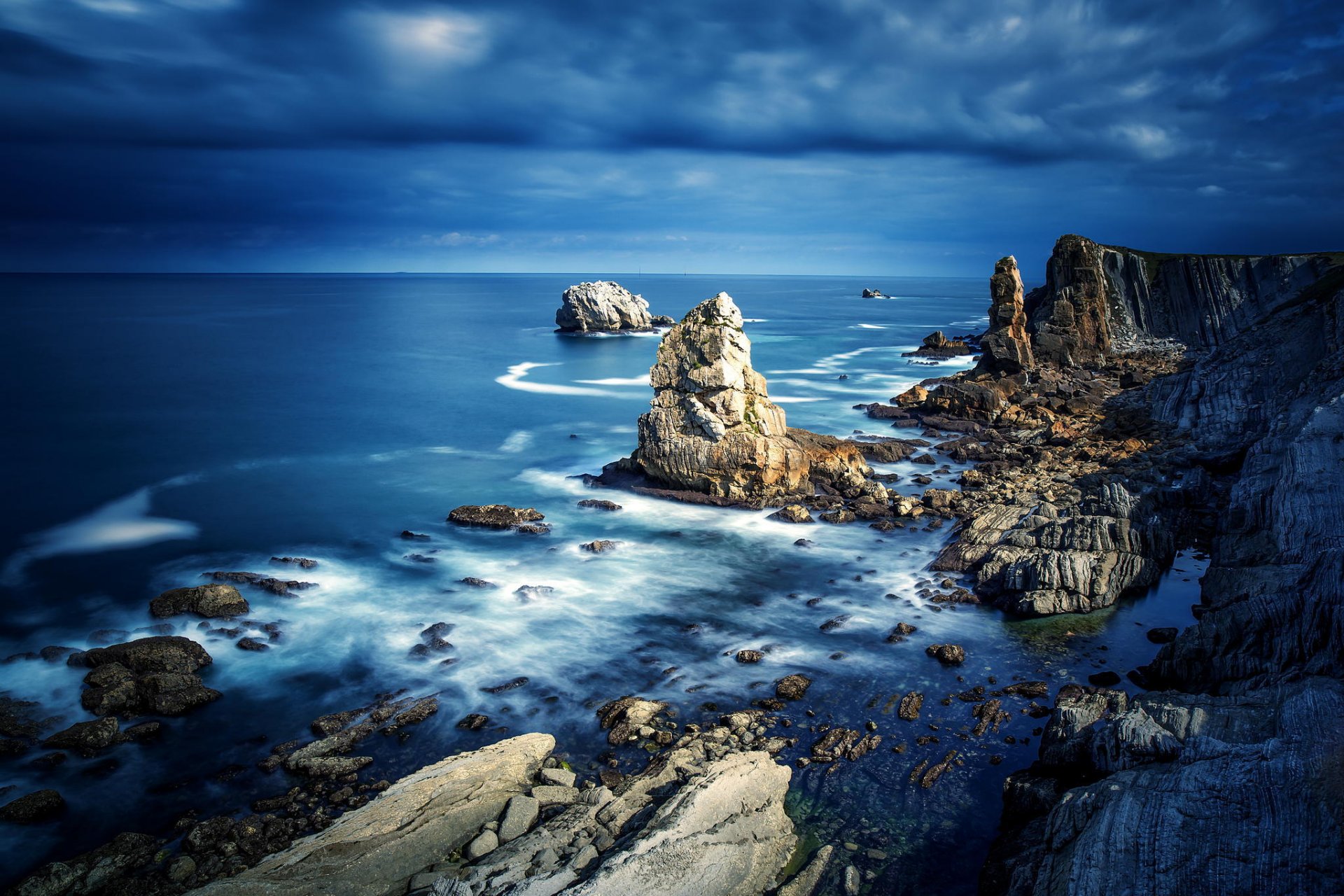 pain sea rock stones beach clouds landscape