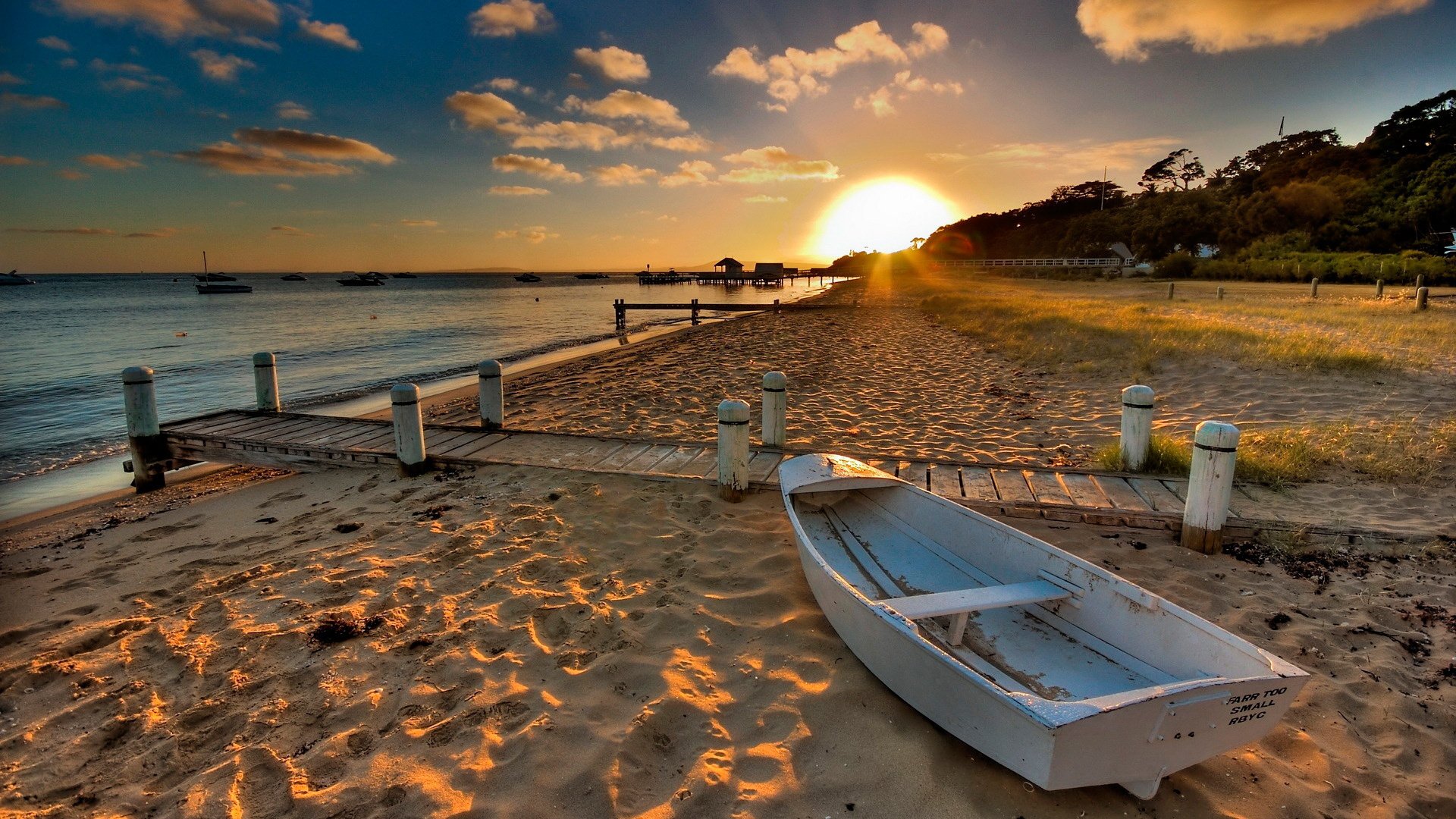 beach sand boat sun sunset water