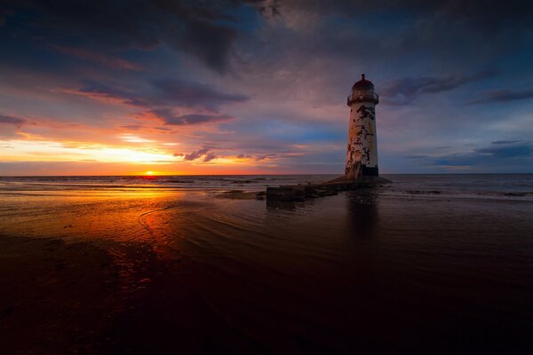 Lonely lighthouse at evening sunset