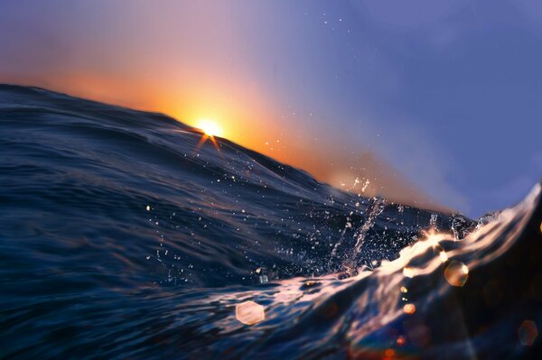 Close-up photo of the sea wave at sunset