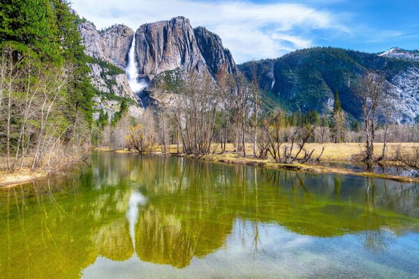 Waterfall flowing into a mountain river in the National Park and the Sierra Nevada