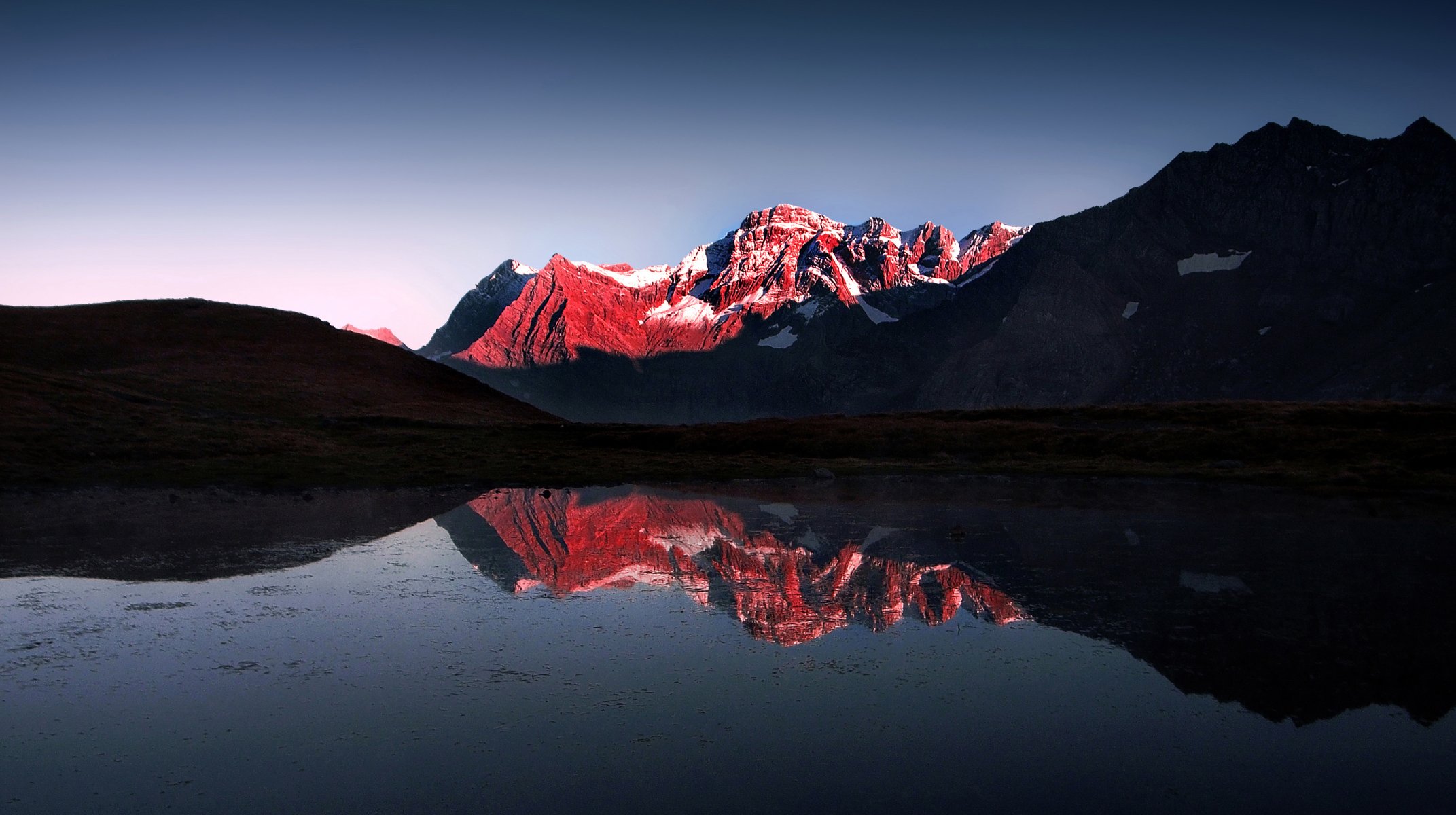 mountain lake snow red light and darkne