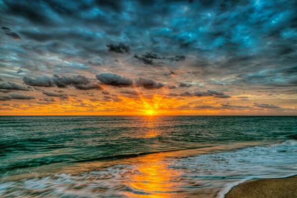 The setting sun over the azure beach