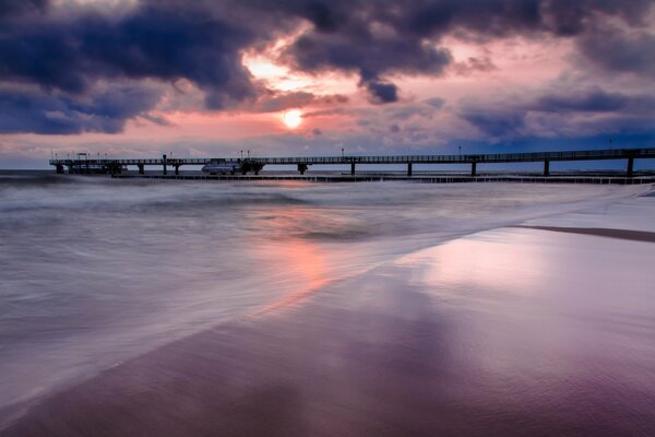 Pier on the background of sunset