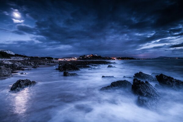 The seashore in the fog under the night sky