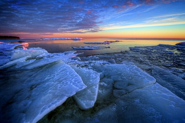 Eisschollen vor dem Hintergrund der Morgendämmerung im Meer