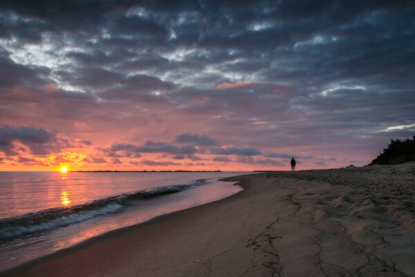 Walking along the sandy beach at dawn