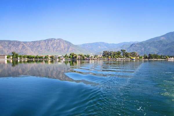 Image of the morning blue sea near the mountains against a clear sky in Turkey