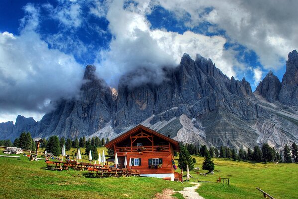 The road to the house on the background of a mountain landscape