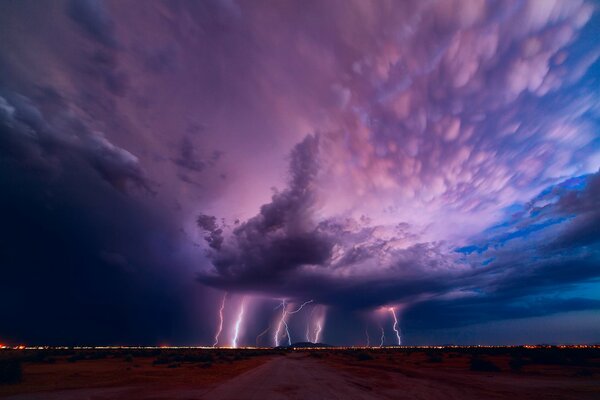 Clouds and lightning in the field along the road