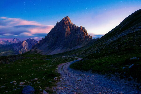 The path passes near a large stone