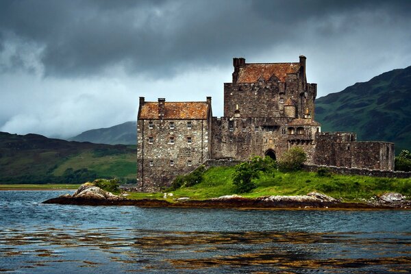 Scottish castle by the lake at night