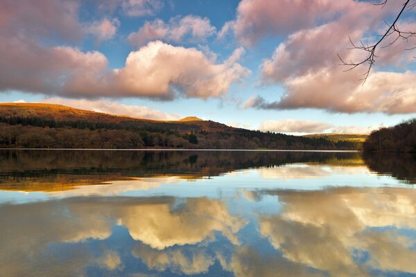 Reflection of clouds and hills in the lake