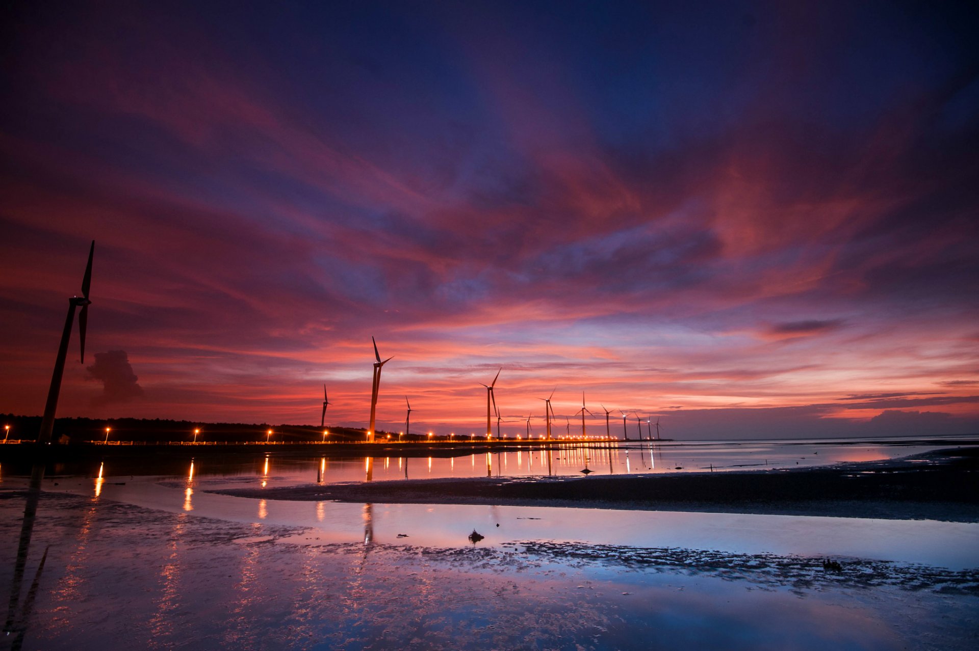 night wind turbines lights light water reflection blue sky sunset cloud