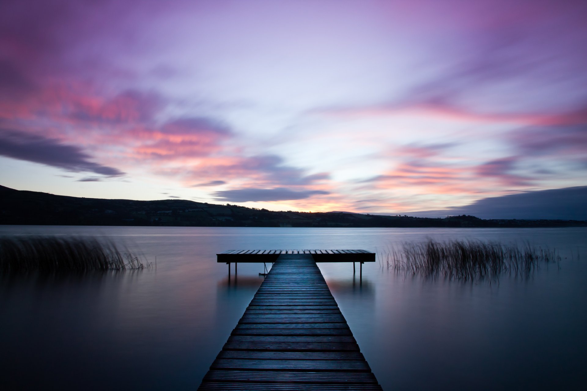 ireland river beach water surface of grass wood bridge night lilac sky cloud