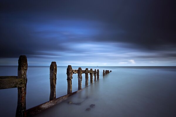 Supports on the seashore against the sky