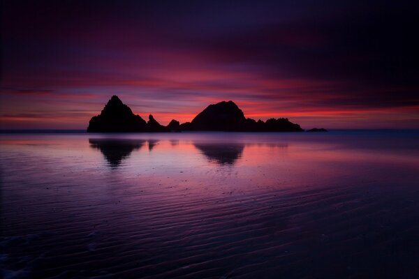 Ocean rocks evening crimson sunset