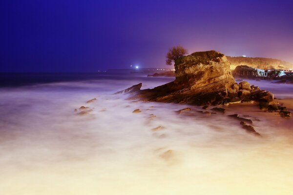 Rocky seashore at foggy sunset