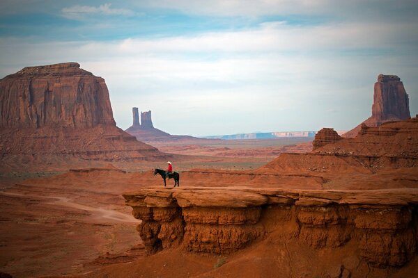 Mountain landscape. The rider on the ledge