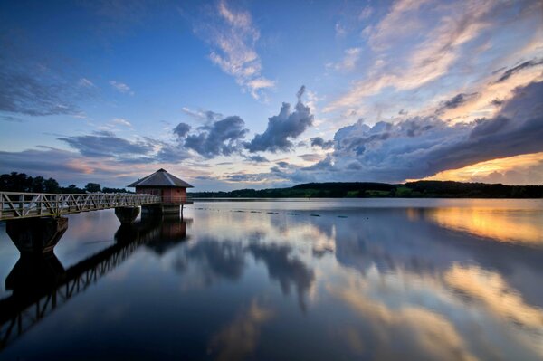 A beautiful cloudy sunset drowns in the river