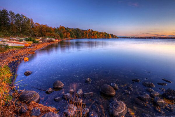 Autumn landscape on the lake with sunset in the sky