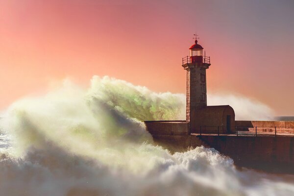 The lighthouse is covered by sea waves