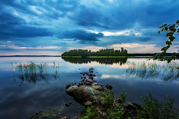 Reflection of clouds in the lake surface. Sunrise