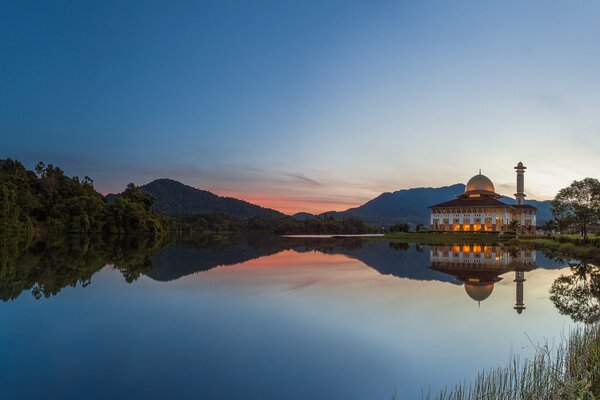 Beautiful lake next to the mosque on the background of mountains